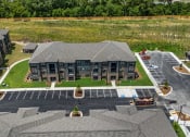 Thumbnail 52 of 57 - an aerial view of a building with cars parked in front of it