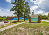 Thumbnail 48 of 57 - a sign for the elementary school sits in front of a road and trees