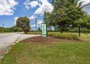 Thumbnail 56 of 57 - a green gas station sign on the side of a road