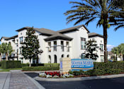 Thumbnail 6 of 40 - Entrance to Lake Nona Water Mark Apartments with Signage at Lake Nona Water Mark in Orlando, FL 32827