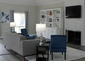 Thumbnail 2 of 8 - Office at Woodland Villas Apartments with plush furnishings, a fireplace, and bookcase with decor at Woodland Villas Apartments, Jasper, AL