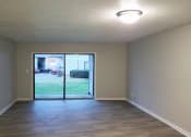 Thumbnail 7 of 8 - an empty room with a door leading out to a yard at Woodland Villas Apartments, Alabama, 35504