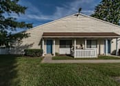 Thumbnail 4 of 9 - A house with a brown roof and a white fence.