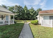 Thumbnail 2 of 9 - A sunny day at a residential area with houses and a clear sky.
