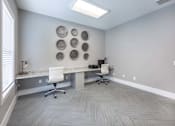 Thumbnail 58 of 197 - A room with a desk, chairs, and a wall decoration at Foxwood Apartments, Raleigh-Durham, 27616