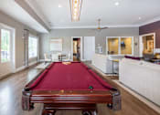 Thumbnail 71 of 197 - A pool table is in the middle of a room with a ceiling fan at Foxwood Apartments, Raleigh-Durham, NC, 27616
