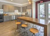 Thumbnail 42 of 197 - A kitchen with a bar area and a wooden counter at Foxwood Apartments, North Carolina, 27616