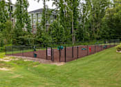Thumbnail 20 of 197 - A green lawn with a fence and a sign at Foxwood Apartments, Raleigh-Durham, 27616