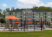 Thumbnail 17 of 197 - A large building with a pool in front of it at Foxwood Apartments, Raleigh-Durham, NC
