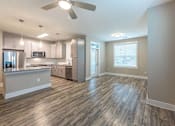 Thumbnail 116 of 197 - A modern kitchen with a wooden floor and a ceiling fan at Foxwood Apartments, Raleigh-Durham