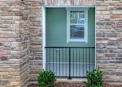 Thumbnail 109 of 197 - A window with a black iron railing and a green wall at Foxwood Apartments, North Carolina, 27616
