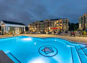Thumbnail 143 of 197 - A swimming pool with a diamond logo in the middle of it. at Foxwood Apartments, Raleigh-Durham, NC
