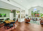Thumbnail 21 of 31 - A well-lit, spacious living room with a dining table and chairs.