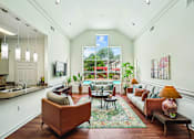 Thumbnail 23 of 31 - A living room with a brown couch and a rug.
