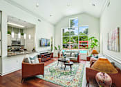 Thumbnail 24 of 31 - A living room with a couch, chairs, and a rug.