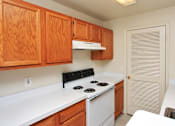Thumbnail 1 of 29 - Kitchen with white stove and wood cabinets