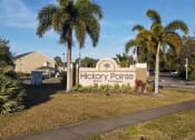 Thumbnail 1 of 15 - Property Sign with landscaping shrubbery underneath it and trees in the back ground
