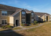 Thumbnail 6 of 15 - Building Exterior with shrubs and sidewalk in front of it