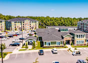Thumbnail 30 of 197 - A parking lot with cars and a building in the background at Foxwood Apartments, North Carolina