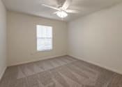 Thumbnail 16 of 24 - Carpeted Bedroom with Window and Ceiling Fan