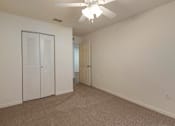 Thumbnail 15 of 24 - Carpeted Room with Folding Closet Door and Ceiling Fan