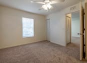 Thumbnail 18 of 24 - Carpeted Bedroom with Window and Ceiling Fan