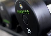 Thumbnail 82 of 197 - A close up of a black dumbbell with the word FOXWOOD and the number 25 printed on it at Foxwood Apartments, Raleigh-Durham, North Carolina