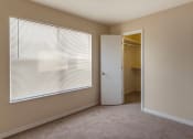 Thumbnail 8 of 31 - Carpeted Bedroom with Window and Walk in Closet