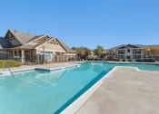 Thumbnail 18 of 27 - Swimming pool with large tanning deck, lounge chairs, pergola and native surrounding landscape