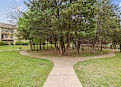 Thumbnail 29 of 33 - A tree-lined walkway in a park.