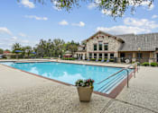 Thumbnail 10 of 33 - A pool with a building behind it.