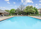 Thumbnail 8 of 33 - A large swimming pool in a sunny outdoor setting.