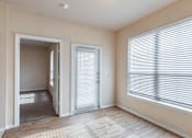 Thumbnail 6 of 33 - a living room with two large windows and a door to the patio