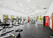 Thumbnail 25 of 33 - the gym with cardio machines and other exercise equipment at the belgard apartments