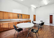 Thumbnail 19 of 33 - a dining room with a table and chairs and a kitchen