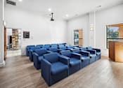Thumbnail 22 of 33 - a conference room with blue chairs and a wood floor