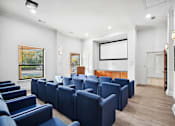 Thumbnail 21 of 33 - a conference room with blue chairs and a projector