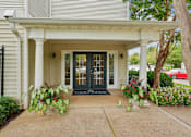 Thumbnail 18 of 29 - A white house with a black gate and a black door.