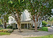 Thumbnail 15 of 29 - A white house with a grey roof is surrounded by trees.