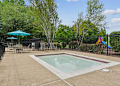 Thumbnail 10 of 29 - A small pool surrounded by a black fence and trees.