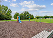 Thumbnail 14 of 29 - A playground with a slide and a seesaw.