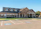 Thumbnail 27 of 27 - A building with a parking lot in front of it.