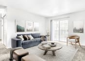 Thumbnail 15 of 25 - Model Living Room with Sliding Glass Patio Door, Coffee Table, Area Rug