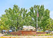 Thumbnail 1 of 25 - Community Sign on Median in Front of Trees and Flagpole