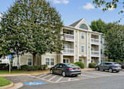 Thumbnail 23 of 29 - A car is parked in a handicapped parking spot in front of a building.