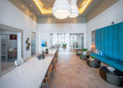 Thumbnail 9 of 58 - a long dining room with a long table and a blue wall