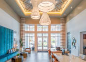 Thumbnail 7 of 58 - a lobby with a long table and chairs and large windows