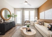 Thumbnail 40 of 58 - a living room with a white couch and a coffee table