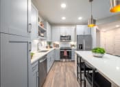 Thumbnail 41 of 58 - a large kitchen with white cabinets and a white counter top