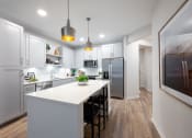 Thumbnail 37 of 58 - a large kitchen with white cabinets and a white counter top